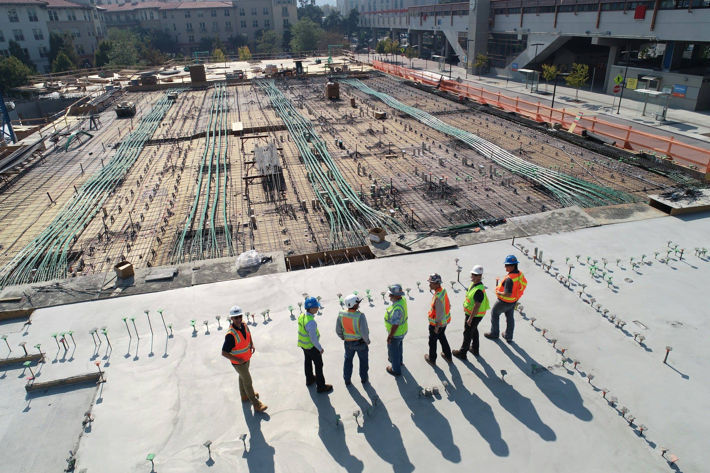 Construction team reviewing a ground-up development site from above